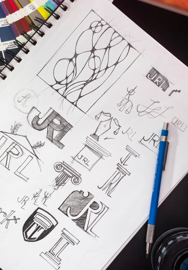 Sketchbook with Lilly Law shield, column, and monogram studies.